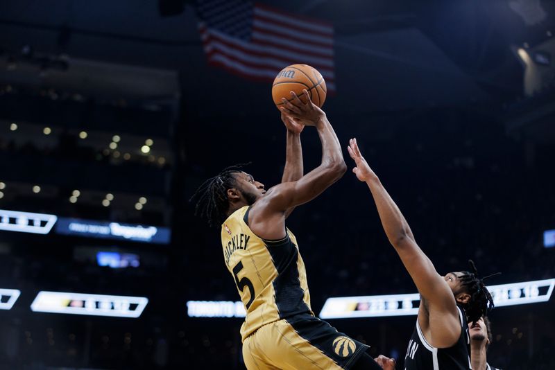 TORONTO, CANADA - FEBRUARY 22: Immanuel Quickley #5 of the Toronto Raptors puts up a shot over Cam Thomas #24 of the Brooklyn Nets in the first half of their NBA game at Scotiabank Arena on February 22, 2024 in Toronto, Canada. NOTE TO USER: User expressly acknowledges and agrees that, by downloading and or using this photograph, User is consenting to the terms and conditions of the Getty Images License Agreement. (Photo by Cole Burston/Getty Images)