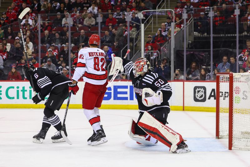 Mar 9, 2024; Newark, New Jersey, USA; New Jersey Devils goaltender Nico Daws (50) makes a save against the Carolina Hurricanes during the third period at Prudential Center. Mandatory Credit: Ed Mulholland-USA TODAY Sports