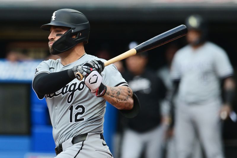 Apr 9, 2024; Cleveland, Ohio, USA; Chicago White Sox center fielder Kevin Pillar (12) hits an RBI double during the first inning against the Cleveland Guardians at Progressive Field. Mandatory Credit: Ken Blaze-USA TODAY Sports