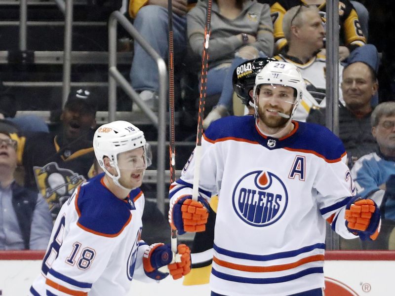 Feb 23, 2023; Pittsburgh, Pennsylvania, USA;Edmonton Oilers center Leon Draisaitl (29) celebrates after scoring a goal against the Pittsburgh Penguins as left wing Zach Hyman (18) looks on during the first period at PPG Paints Arena. Edmonton won 7-2. Mandatory Credit: Charles LeClaire-USA TODAY Sports