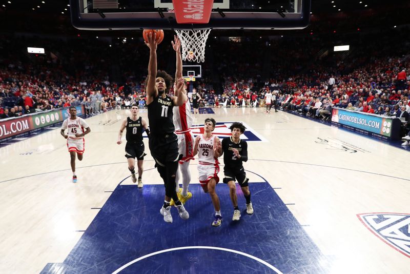 Feb 18, 2023; Tucson, Arizona, USA; Colorado Buffaloes guard Javon Ruffin (11) makes a basket against Arizona Wildcats guard Pelle Larsson (3) during the second half at McKale Center. Mandatory Credit: Zachary BonDurant-USA TODAY Sports