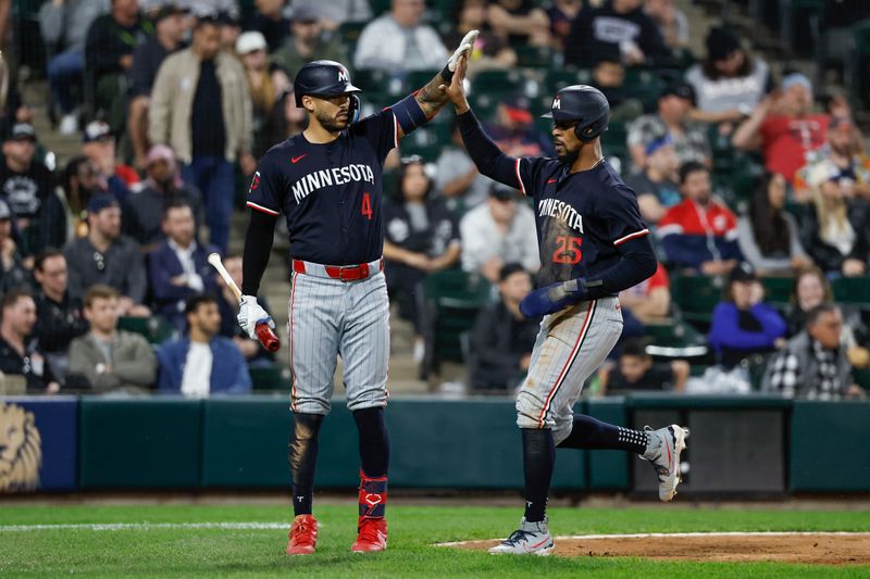 Apr 30, 2024; Chicago, Illinois, USA; Minnesota Twins outfielder Byron Buxton (25) celebrates with shortstop Carlos Correa (4) after scoring against the Chicago White Sox during the ninth inning at Guaranteed Rate Field. Mandatory Credit: Kamil Krzaczynski-USA TODAY Sports