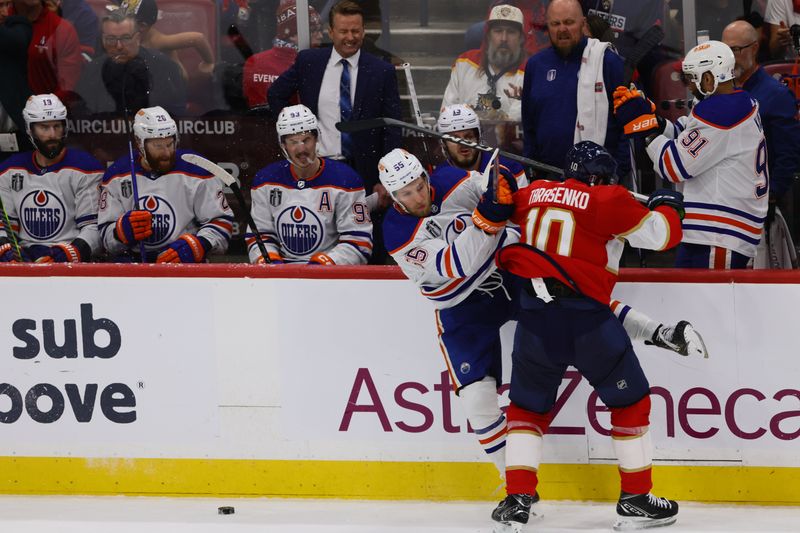 Jun 10, 2024; Sunrise, Florida, USA; Florida Panthers forward Vladimir Tarasenko (10) boards Edmonton Oilers forward Dylan Holloway (55) during the first period in game two of the 2024 Stanley Cup Final at Amerant Bank Arena. Mandatory Credit: Sam Navarro-USA TODAY Sports