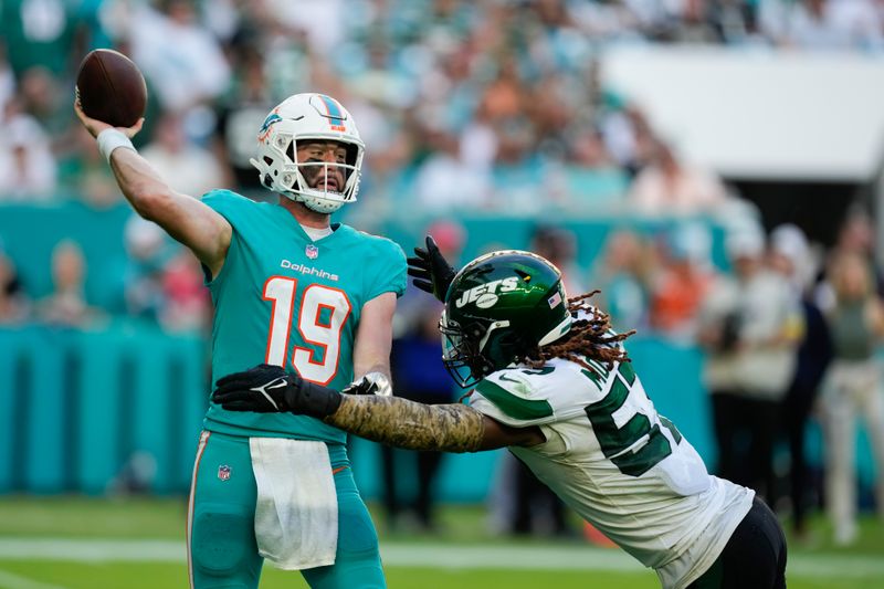 Miami Dolphins quarterback Skylar Thompson (19) passes under pressure from New York Jets linebacker C.J. Mosley (57) during the second half of an NFL football game, Sunday, Jan. 8, 2023, in Miami Gardens, Fla. (AP Photo/Rebecca Blackwell)