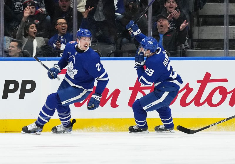 Jan 9, 2024; Toronto, Ontario, CAN; Toronto Maple Leafs right wing Pontus Holmberg (29) scores a goal and celebrates with Toronto Maple Leafs defenseman Simon Benoit (2) against the San Jose Sharks during the second period at Scotiabank Arena. Mandatory Credit: Nick Turchiaro-USA TODAY Sports