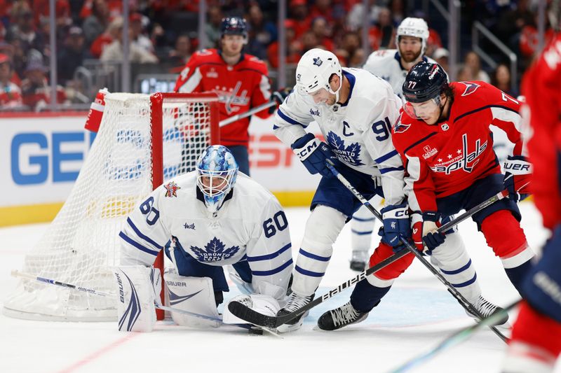 Oct 24, 2023; Washington, District of Columbia, USA; Toronto Maple Leafs center John Tavares (91) and Washington Capitals right wing T.J. Oshie (77) battle for the puck in front of Toronto Maple Leafs goaltender Joseph Woll (60) in the third period at Capital One Arena. Mandatory Credit: Geoff Burke-USA TODAY Sports