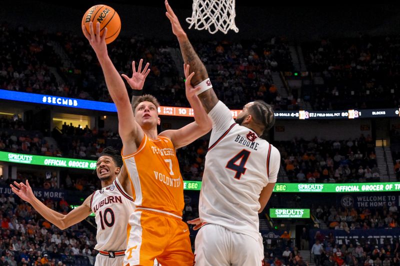 Mar 15, 2025; Nashville, TN, USA;  Tennessee Volunteers forward Igor Milicic Jr. (7) lays the ball in over Auburn Tigers forward Johni Broome (4) during the first half at Bridgestone Arena. Mandatory Credit: Steve Roberts-Imagn Images