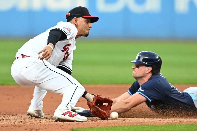 Sep 14, 2024; Cleveland, Ohio, USA; Tampa Bay Rays left fielder Josh Lowe (15) steals second as Cleveland Guardians second baseman Andres Gimenez (0) waits for the throw during the fifth inning at Progressive Field. Mandatory Credit: Ken Blaze-Imagn Images