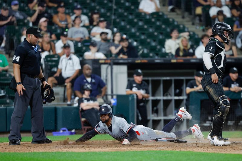 Jul 8, 2024; Chicago, Illinois, USA; Minnesota Twins outfielder Byron Buxton (25) scores against the Chicago White Sox during the 11th inning at Guaranteed Rate Field. Mandatory Credit: Kamil Krzaczynski-USA TODAY Sports