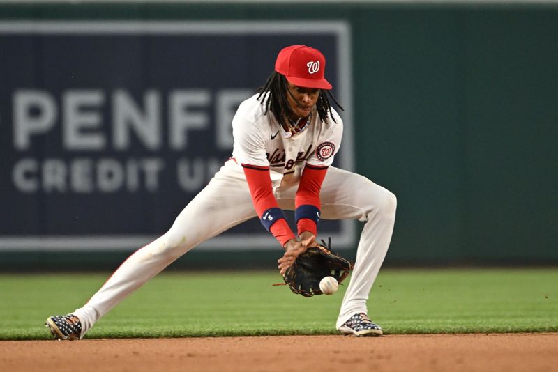 Jul 1, 2024; Washington, District of Columbia, USA; Washington Nationals shortstop CJ Abrams (5) fields a ground ball against the New York Mets during the seventh inning at Nationals Park. Mandatory Credit: Rafael Suanes-USA TODAY Sports