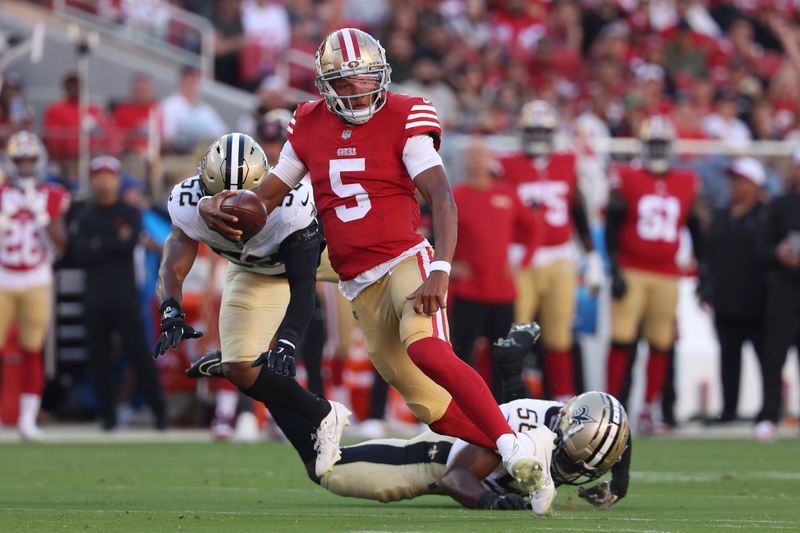 San Francisco 49ers quarterback Joshua Dobbs (5) runs against the New Orleans Saints during the first half of a preseason NFL football game in Santa Clara, Calif., Sunday, Aug. 18, 2024. (AP Photo/Jed Jacobsohn)