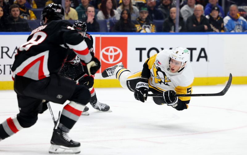 Feb 5, 2026; Buffalo, New York, USA;  Pittsburgh Penguins defenseman Ryan Shea (5) dives as he takes a shot on goal during the first period against the Buffalo Sabres at KeyBank Center. Mandatory Credit: Timothy T. Ludwig-Imagn Images