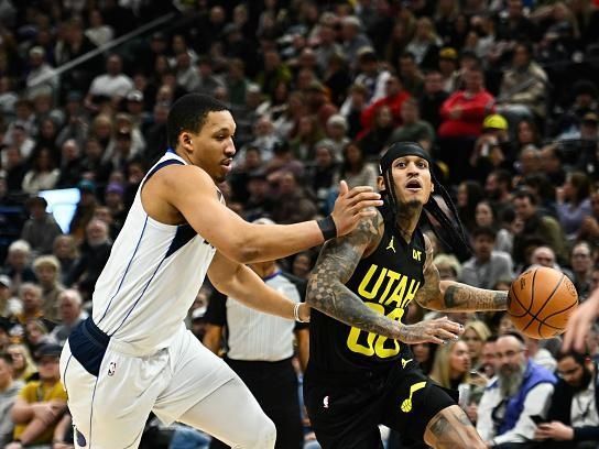 SALT LAKE CITY, UTAH - JANUARY 01: Jordan Clarkson #00 of the Utah Jazz drives past Grant Williams #3 of the Dallas Mavericks during the first half of a game at Delta Center on January 01, 2024 in Salt Lake City, Utah. NOTE TO USER: User expressly acknowledges and agrees that, by downloading and or using this photograph, User is consenting to the terms and conditions of the Getty Images License Agreement. (Photo by Alex Goodlett/Getty Images)