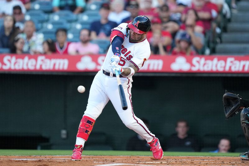 Jul 11, 2025; Anaheim, California, USA; Los Angeles Angels third baseman Yoan Moncada (5) hits a two-run home run in the first inning against the Arizona Diamondbacks at Angel Stadium. Mandatory Credit: Kirby Lee-Imagn Images