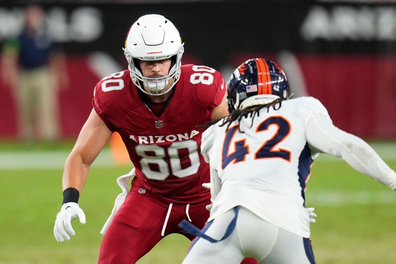 Arizona Cardinals tight end Bernhard Seikovits (80) gets ready to block Denver Broncos linebacker Nik Bonitto (42) during the first half of an NFL preseason football game, Friday, Aug. 11, 2023, in Glendale, Ariz. (AP Photo/Ross D. Franklin)