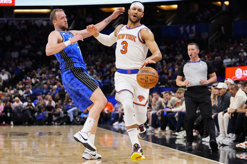 ORLANDO, FLORIDA - FEBRUARY 14: Joe Ingles #7 of the Orlando Magic fouls Josh Hart #3 of the New York Knicks during the second quarter at Kia Center on February 14, 2024 in Orlando, Florida. NOTE TO USER: User expressly acknowledges and agrees that, by downloading and or using this photograph, user is consenting to the terms and conditions of the Getty Images License Agreement. (Photo by Rich Storry/Getty Images)