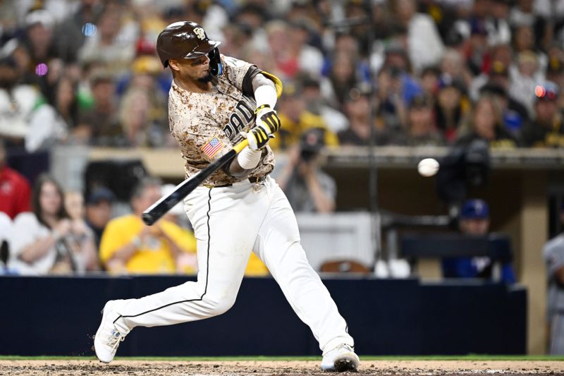 Jul 6, 2025; San Diego, California, USA; San Diego Padres catcher Martin Maldonado (15) hits an RBI single during the sixth inning against the Texas Rangers at Petco Park. Mandatory Credit: Denis Poroy-Imagn Images