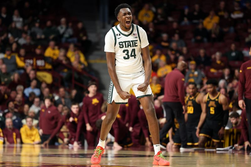 Dec 4, 2024; Minneapolis, Minnesota, USA; Michigan State Spartans forward Xavier Booker (34) celebrates his three-point basket against the Minnesota Golden Gophers during the second half at Williams Arena. Mandatory Credit: Matt Krohn-Imagn Images