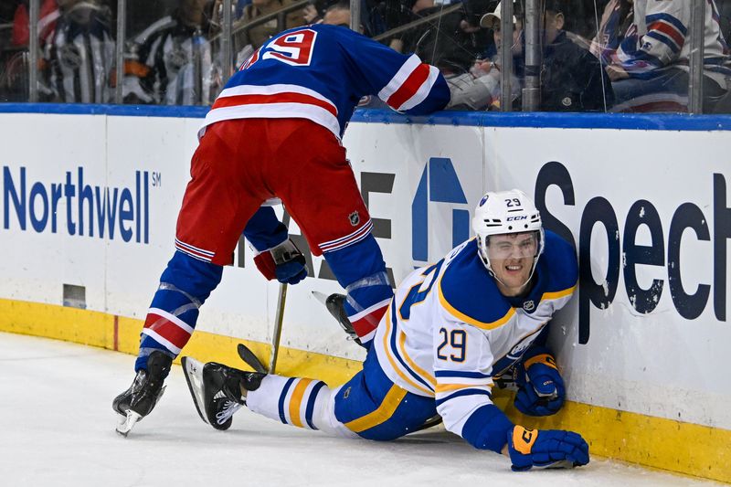 Nov 7, 2024; New York, New York, USA;  New York Rangers center Sam Carrick (39) checks Buffalo Sabres left wing Beck Malenstyn (29) into the boards during the third period at Madison Square Garden. Mandatory Credit: Dennis Schneidler-Imagn Images