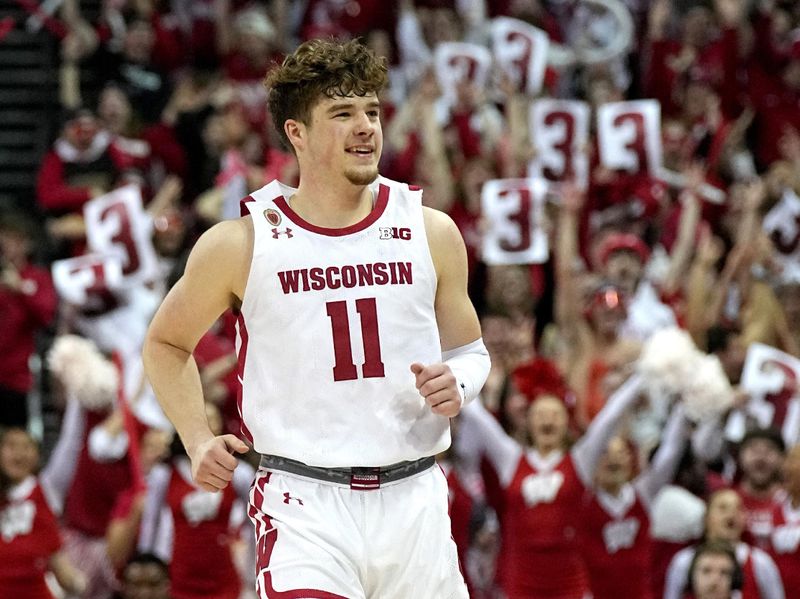 Mar. 2, 2023; Milwaukee, Wisconsin, USA; Wisconsin Badgers guard Max Klesmit (11) reacts after hitting a three-point basket during the second half of their game against the Purdue Boilermakers at Kohl Center. Mandatory Credit: Mark Hoffman-USA TODAY Sports