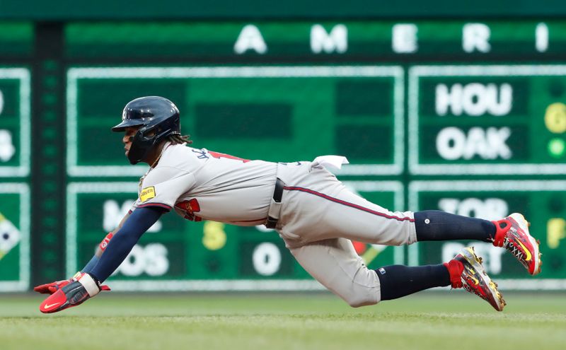 May 25, 2024; Pittsburgh, Pennsylvania, USA;  Atlanta Braves right fielder Ronald Acuña Jr. (13) dives to steal second base against the Pittsburgh Pirates during the fifth inning at PNC Park. Mandatory Credit: Charles LeClaire-USA TODAY Sports