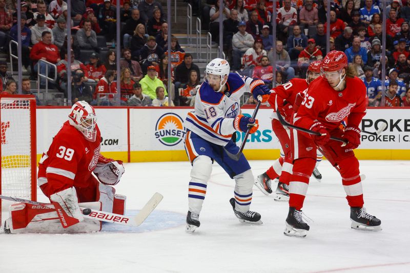 Oct 27, 2024; Detroit, Michigan, USA; Detroit Red Wings goaltender Cam Talbot (39) makes a save while Edmonton Oilers left wing Zach Hyman (18) and Detroit Red Wings defenseman Moritz Seider (53) look on during the third period of the game at Little Caesars Arena. Mandatory Credit: Brian Bradshaw Sevald-Imagn Images