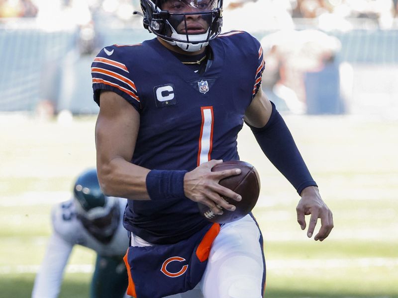 Chicago Bears quarterback Justin Fields (1) rushes with the ball during the first half of an NFL football game against the Philadelphia Eagles, Sunday, Dec. 18, 2022, in Chicago. (AP Photo/Kamil Krzaczynski)