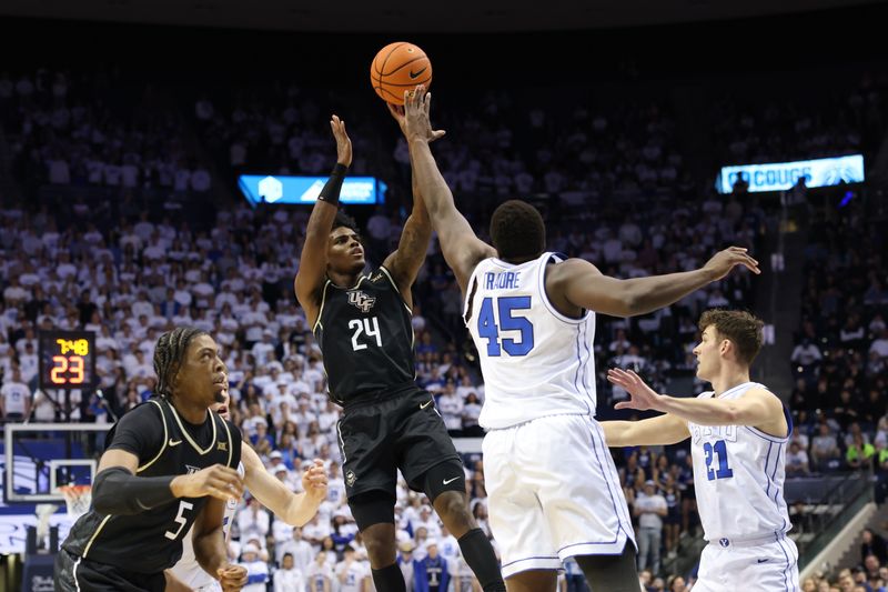 Feb 13, 2024; Provo, Utah, USA; Central Florida Knights guard Jaylin Sellers (24) shoots against Brigham Young Cougars forward Fousseyni Traore (45) during the first half at Marriott Center. Mandatory Credit: Rob Gray-USA TODAY Sports