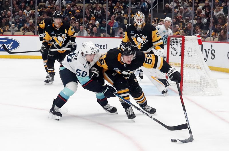 Jan 15, 2024; Pittsburgh, Pennsylvania, USA; Pittsburgh Penguins center Noel Acciari (55) reaches for a loose puck against Seattle Kraken right wing Kailer Yamamoto (56) during the second period at PPG Paints Arena. Mandatory Credit: Charles LeClaire-USA TODAY Sports