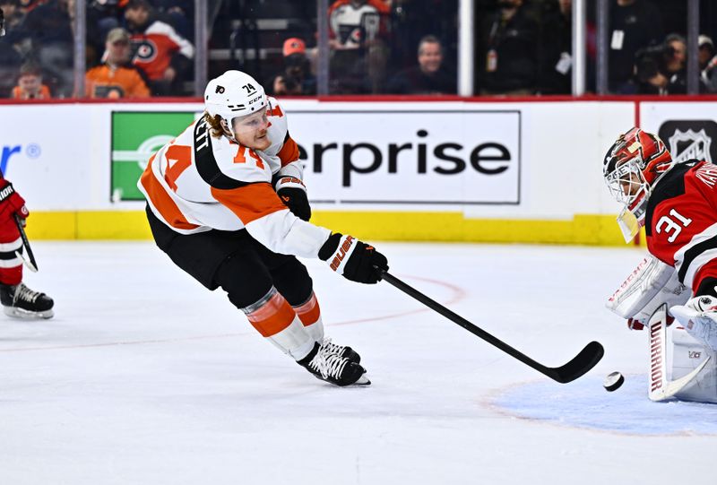 Apr 13, 2024; Philadelphia, Pennsylvania, USA; Philadelphia Flyers right wing Owen Tippett (74) shoots against New Jersey Devils goalie Kaapo Kahkonen (31) in the third period at Wells Fargo Center. Mandatory Credit: Kyle Ross-USA TODAY Sports