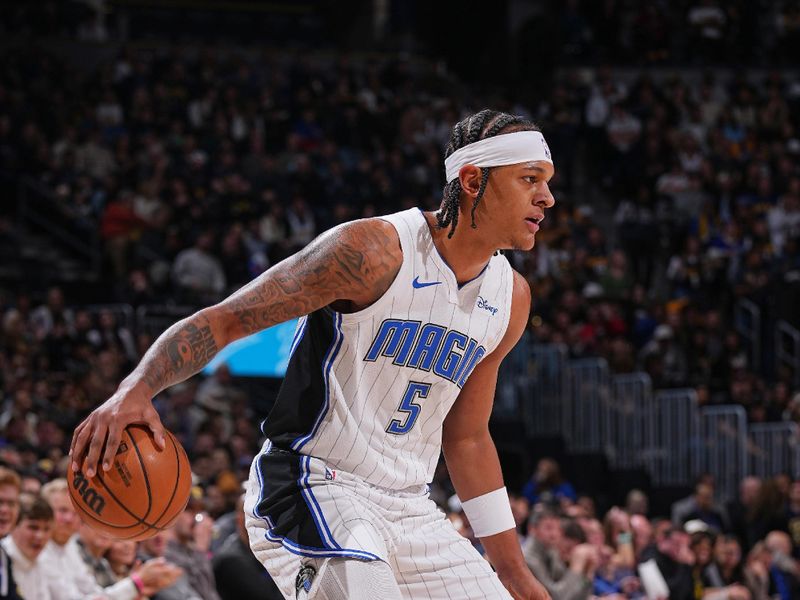 DENVER, CO - JANUARY 5: Paolo Banchero #5 of the Orlando Magic dribbles the ball during the game against the Denver Nuggets on January 5, 2024 at the Ball Arena in Denver, Colorado. NOTE TO USER: User expressly acknowledges and agrees that, by downloading and/or using this Photograph, user is consenting to the terms and conditions of the Getty Images License Agreement. Mandatory Copyright Notice: Copyright 2024 NBAE (Photo by Bart Young/NBAE via Getty Images)