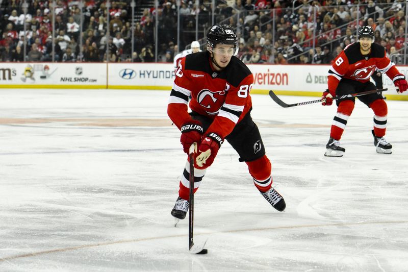 Oct 19, 2024; Newark, New Jersey, USA; New Jersey Devils center Jack Hughes (86) skates with the puck against the Washington Capitals during the second period at Prudential Center. Mandatory Credit: John Jones-Imagn Images