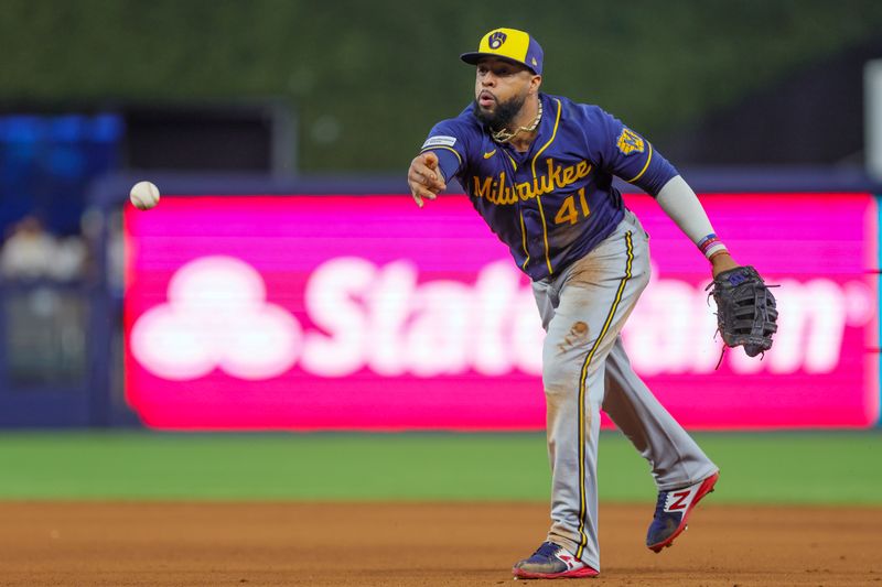 Sep 24, 2023; Miami, Florida, USA; Milwaukee Brewers first baseman Carlos Santana (41) tosses the baseball to relief pitcher J.B. Bukauskas (not pictured) and retires Miami Marlins catcher Jacob Stallings (not pictured) during the seventh inning at loanDepot Park. Mandatory Credit: Sam Navarro-USA TODAY Sports