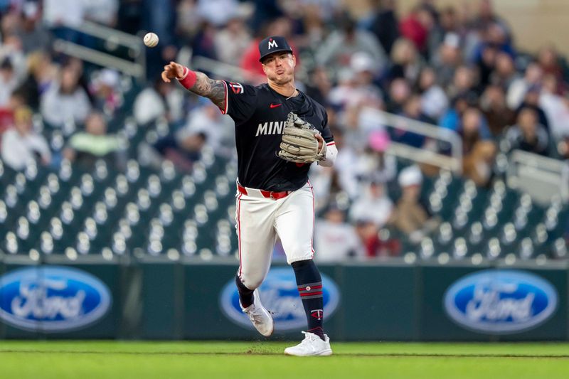 Apr 22, 2024; Minneapolis, Minnesota, USA; Minnesota Twins third baseman Jose Miranda (64) throws the ball to first base for an out against the Chicago White Sox in the sixth inning at Target Field. Mandatory Credit: Jesse Johnson-USA TODAY Sports