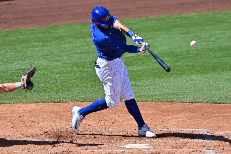 Mar 8, 2024; Mesa, Arizona, USA;  Chicago Cubs shortstop Dansby Swanson (7) hits an RBI single in the second inning against the Seattle Mariners during a spring training game at Sloan Park. Mandatory Credit: Matt Kartozian-USA TODAY Sports