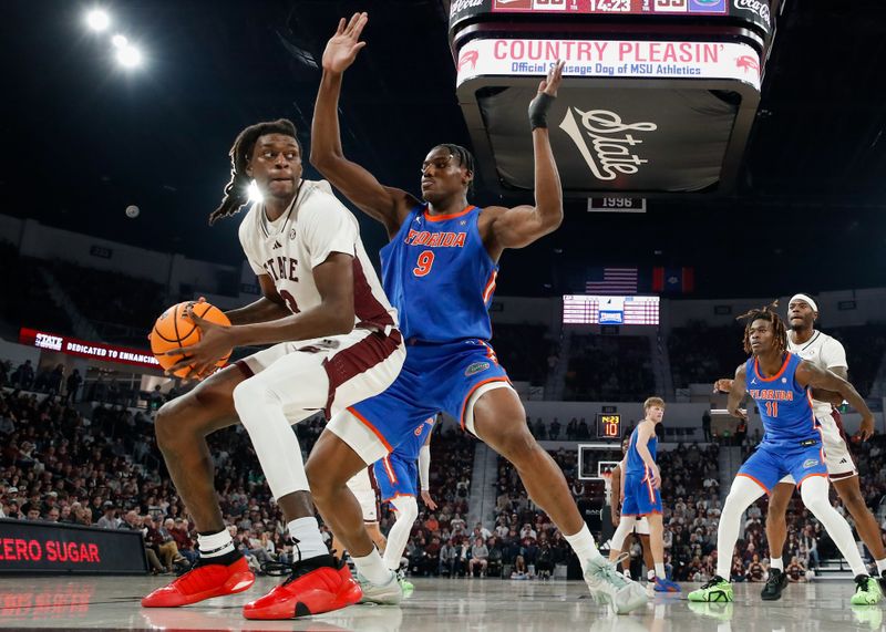 Feb 11, 2025; Starkville, Mississippi, USA; Mississippi State Bulldogs forward KeShawn Murphy (3) handles the ball against Florida Gators center Rueben Chinyelu (9) during the second half at Humphrey Coliseum. Mandatory Credit: Wesley Hale-Imagn Images