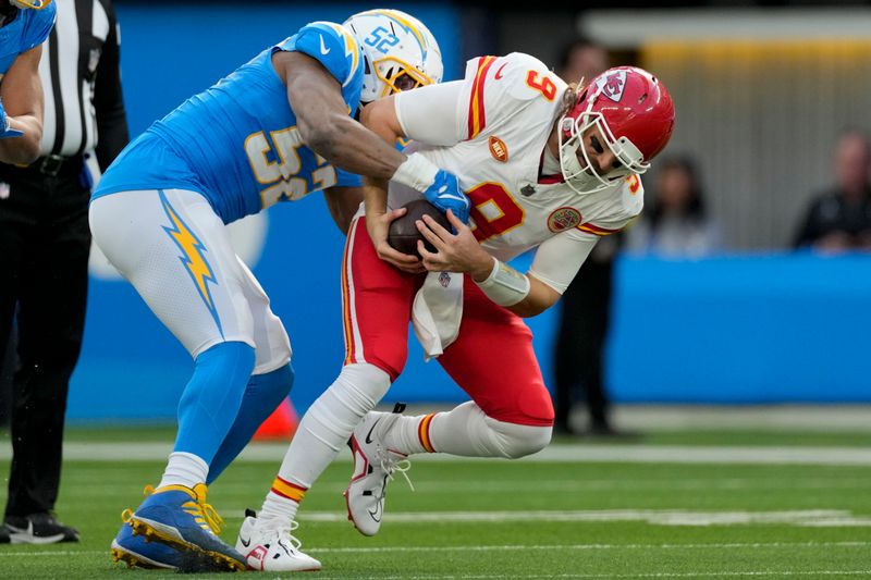 Kansas City Chiefs quarterback Blaine Gabbert, right, is sacked by Los Angeles Chargers linebacker Khalil Mack during the first half of an NFL football game, Sunday, Jan. 7, 2024, in Inglewood, Calif. (AP Photo/Ashley Landis)