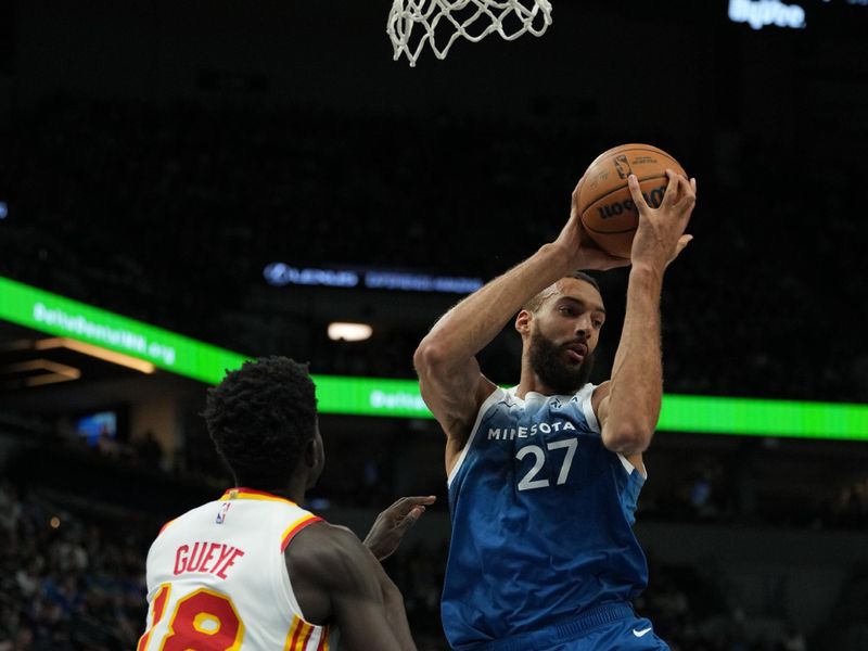 MINNEAPOLIS, MN -  APRIL 12: Rudy Gobert #27 of the Minnesota Timberwolves rebounds the ball during the game against the Atlanta Hawks on April 12, 2024 at Target Center in Minneapolis, Minnesota. NOTE TO USER: User expressly acknowledges and agrees that, by downloading and or using this Photograph, user is consenting to the terms and conditions of the Getty Images License Agreement. Mandatory Copyright Notice: Copyright 2024 NBAE (Photo by Jordan Johnson/NBAE via Getty Images)