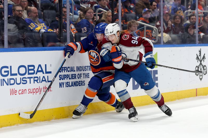 Jan 28, 2025; Elmont, New York, USA; New York Islanders center Bo Horvat (14) and Colorado Avalanche left wing Joel Kiviranta (94) fight for the puck during the third period at UBS Arena. Mandatory Credit: Brad Penner-Imagn Images