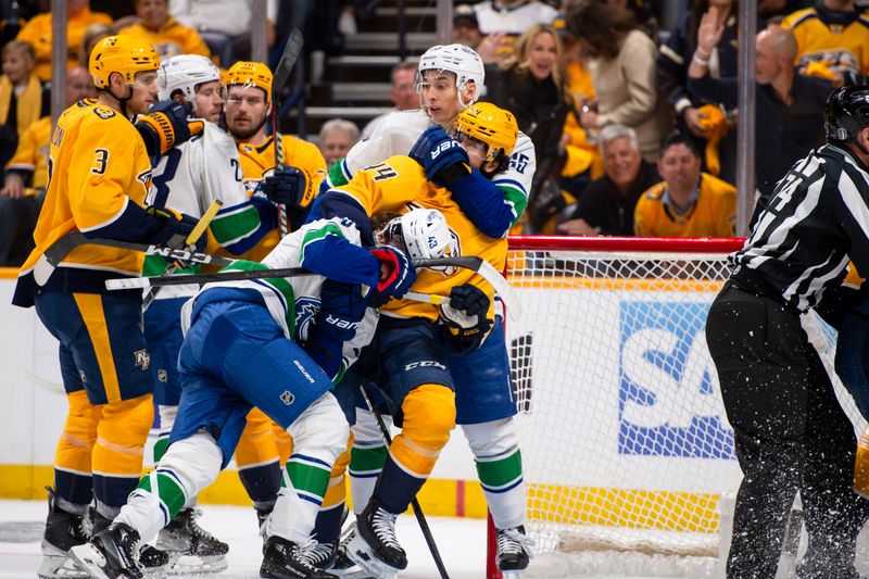 Apr 26, 2024; Nashville, Tennessee, USA; Nashville Predators center Gustav Nyquist (14), Vancouver Canucks right wing Ilya Mikheyev (65), and defenseman Quinn Hughes (43) fight during the first period in game three of the first round of the 2024 Stanley Cup Playoffs at Bridgestone Arena. Mandatory Credit: Steve Roberts-USA TODAY Sports