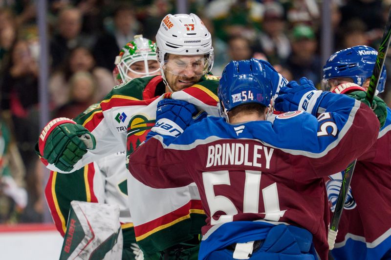 Dec 21, 2025; Saint Paul, Minnesota, USA; Colorado Avalanche center Gavin Brindley (54) and Minnesota Wild left wing Marcus Foligno (17) fight in the second period at Grand Casino Arena. Mandatory Credit: Matt Blewett-Imagn Images