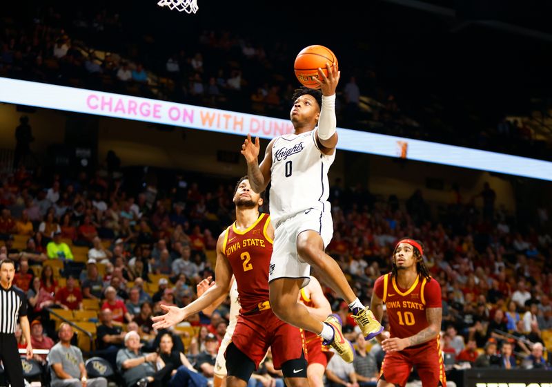 Feb 11, 2025; Orlando, Florida, USA;  Central Florida Knights guard Jordan Ivy-Curry (0) goes up for a shot against the Iowa State Cyclones at Addition Financial Arena. Mandatory Credit: Russell Lansford-Imagn Images