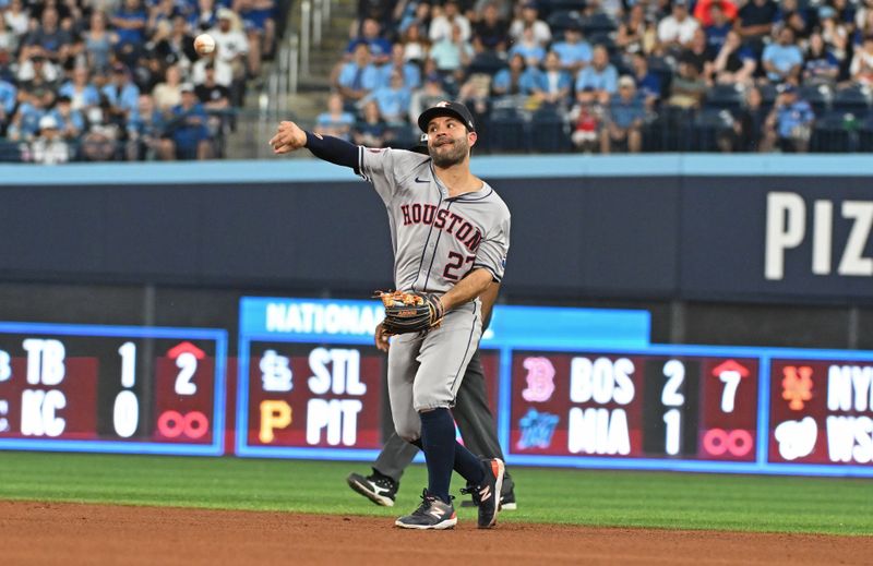 Jul 3, 2024; Toronto, Ontario, CAN; Houston Astros second baseman Jose Altuve (27) fields a ground ball in the fourth inning against the Toronto Blue Jays at Rogers Centre. Mandatory Credit: Gerry Angus-USA TODAY Sports