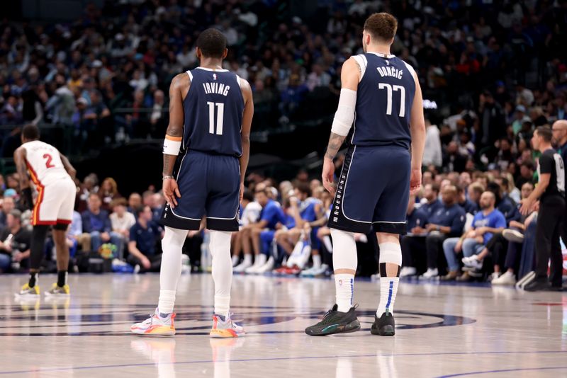 DALLAS, TEXAS - MARCH 07: Kyrie Irving #11 and Luka Doncic #77 of the Dallas Mavericks stand on the court in the first half against the Miami Heat at American Airlines Center on March 07, 2024 in Dallas, Texas.  NOTE TO USER: User expressly acknowledges and agrees that, by downloading and or using this photograph, User is consenting to the terms and conditions of the Getty Images License Agreement. (Photo by Tim Heitman/Getty Images)