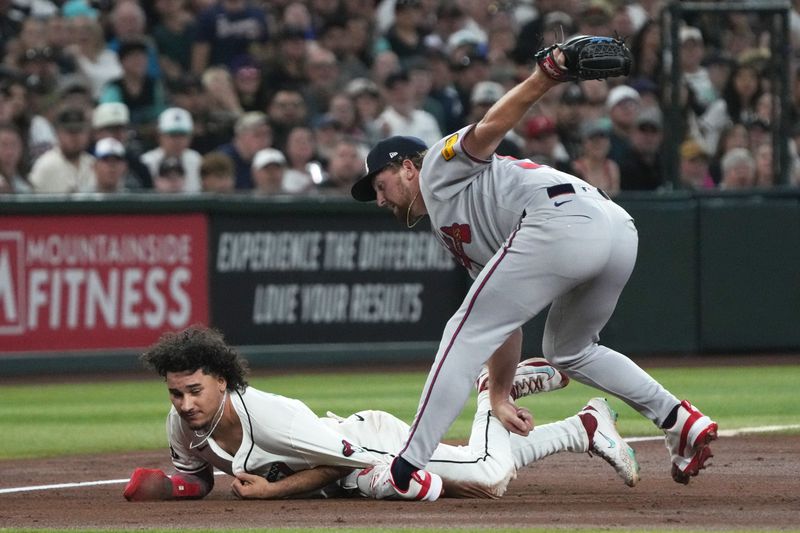 Apr 27, 2025; Phoenix, Arizona, USA; Atlanta Braves pitcher Spencer Schwellenbach (56) tags out Arizona Diamondbacks outfielder Alek Thomas (5) in the second inning at Chase Field. Mandatory Credit: Rick Scuteri-Imagn Images