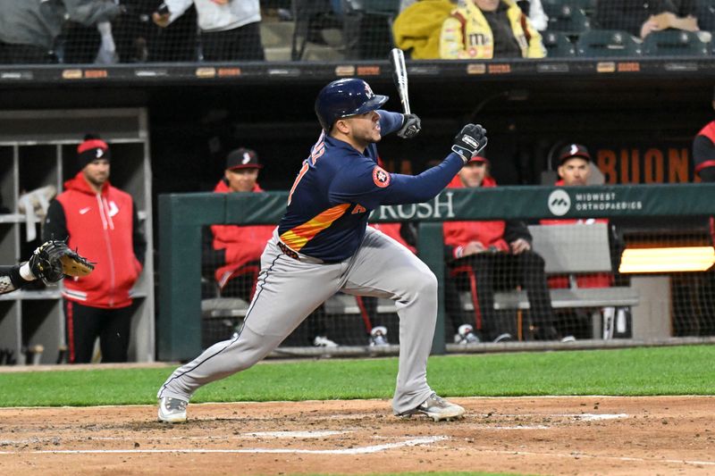 May 2, 2025; Chicago, Illinois, USA;  Houston Astros catcher Yainer Diaz (21) hits an RBI double during the fourth inning against the Chicago White Sox at Rate Field. Mandatory Credit: Matt Marton-Imagn Images