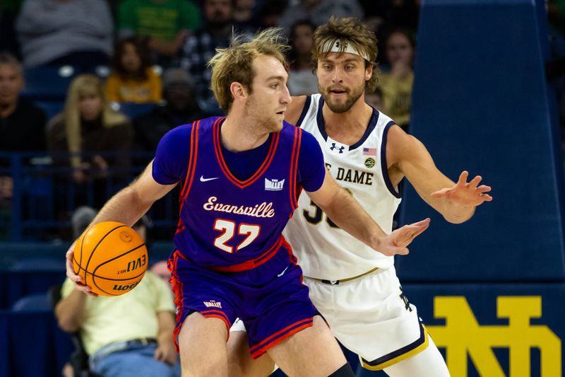 Dec 13, 2025; South Bend, Indiana, USA; Evansville Purple Aces forward Connor Turnbull (22) dribbles against Notre Dame Fighting Irish forward Carson Towt (33) during the first half at Purcell Pavilion at the Joyce Center. Mandatory Credit: Michael Caterina-Imagn Images