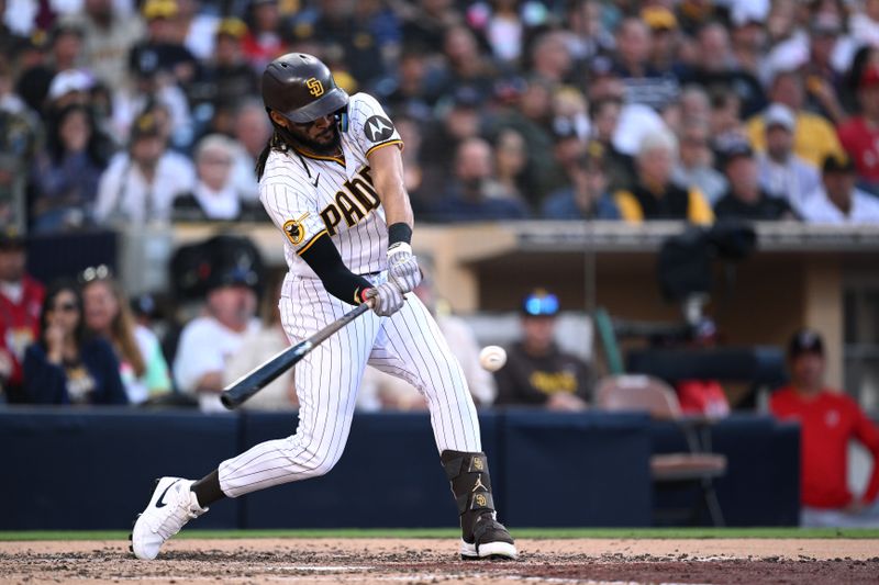 Jun 24, 2023; San Diego, California, USA; San Diego Padres right fielder Fernando Tatis Jr. (23) hits a single against the Washington Nationals during the fifth inning at Petco Park. Mandatory Credit: Orlando Ramirez-USA TODAY Sports