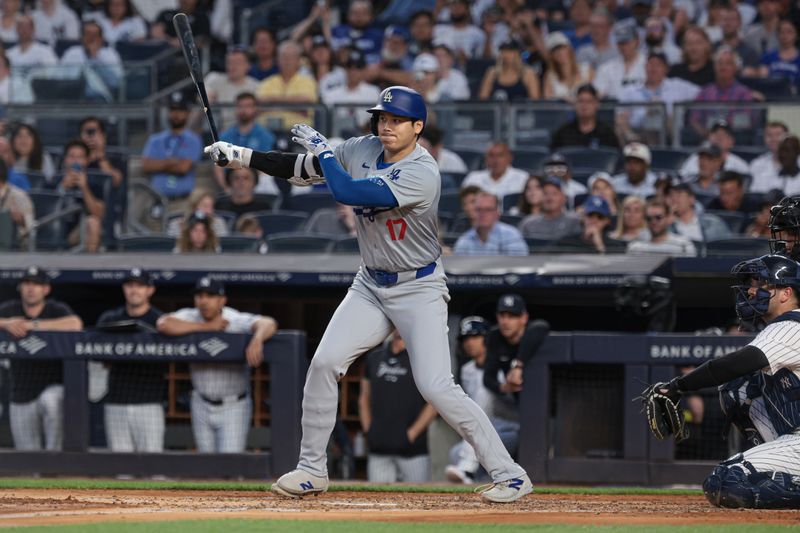 Jun 8, 2024; Bronx, New York, USA; Los Angeles Dodgers designated hitter Shohei Ohtani (17) hits an RBI single during the third inning against the New York Yankees at Yankee Stadium. Mandatory Credit: Vincent Carchietta-USA TODAY Sports