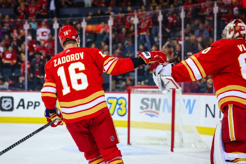 Nov 1, 2022; Calgary, Alberta, CAN; Calgary Flames defenseman Nikita Zadorov (16) celebrates his goal with goaltender Dan Vladar (80) during the second period against the Seattle Kraken at Scotiabank Saddledome. Mandatory Credit: Sergei Belski-USA TODAY Sports